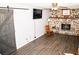 Spacious living area featuring a stone fireplace, a dark barn door, and stylish vinyl floors at 2592 King Louis Ne Rd, Conyers, GA 30012