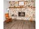Living room featuring a decorative stone fireplace and wood floors at 2592 King Louis Ne Rd, Conyers, GA 30012