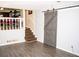 Living room with barn door and stairs to another level at 2592 King Louis Ne Rd, Conyers, GA 30012
