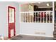Cozy interior view with vinyl floors, stairs to the kitchen, and a vibrant red door at 2592 King Louis Ne Rd, Conyers, GA 30012