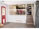 Cozy interior view with vinyl floors, stairs to the kitchen, and a vibrant red door at 2592 King Louis Ne Rd, Conyers, GA 30012