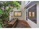 Exterior of a screened in porch with a wooden bench in a lush backyard at 4096 Audubon Dr, Marietta, GA 30068