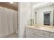 Bathroom featuring marble countertops, white cabinets and a shower behind a white curtain at 4096 Audubon Dr, Marietta, GA 30068