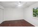 A bright bedroom features dark hardwood floors and a white ceiling fan at 4096 Audubon Dr, Marietta, GA 30068