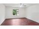 Bedroom with wood floors and large window with outdoor view at 4096 Audubon Dr, Marietta, GA 30068