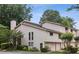 A charming townhouse featuring neutral siding, attached garages, and a well-manicured lawn with mature trees at 4096 Audubon Dr, Marietta, GA 30068