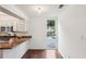 Kitchen features white cabinets, wood floors, and an expansive window for lots of natural light at 4096 Audubon Dr, Marietta, GA 30068