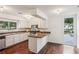 Well-lit kitchen featuring white cabinets, wood floors, and stainless steel appliances at 4096 Audubon Dr, Marietta, GA 30068