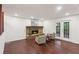 Inviting living room featuring a cozy brick fireplace and double doors to the deck at 4096 Audubon Dr, Marietta, GA 30068