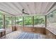 Inviting screened-in porch with wood floors and a ceiling fan for warm days at 4096 Audubon Dr, Marietta, GA 30068