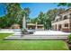 A beautiful backyard showcasing a luxury home, pool, pool house and lush landscaping at 4309 Sentinel Post Nw Rd, Atlanta, GA 30327
