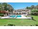 Luxurious backyard features a sparkling pool, covered outdoor kitchen, and expansive green space perfect for entertaining at 4309 Sentinel Post Nw Rd, Atlanta, GA 30327