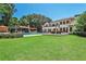 An expansive backyard showcases a luxury home, pool, lounging area and lush landscaping at 4309 Sentinel Post Nw Rd, Atlanta, GA 30327