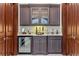 Charming bar area with wine fridge, custom cabinets, marble countertop, and stylish decor at 4309 Sentinel Post Nw Rd, Atlanta, GA 30327