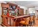 This wet bar features hardwood cabinets and countertops, seating, and a mirror and tv on the wall at 4309 Sentinel Post Nw Rd, Atlanta, GA 30327