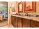 Bathroom with double vanity with granite countertop, wood cabinetry, and framed mirrors at 4309 Sentinel Post Nw Rd, Atlanta, GA 30327