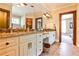 Bathroom features granite countertops, and sinks, and wooden door and trim at 4309 Sentinel Post Nw Rd, Atlanta, GA 30327