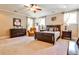 This bedroom features natural light, neutral tones, carpet, and stylish ceiling fan and décor at 4309 Sentinel Post Nw Rd, Atlanta, GA 30327