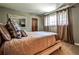 Comfortable bedroom with neutral tones, large window with natural light, decorative mirror, and plush bedding at 4309 Sentinel Post Nw Rd, Atlanta, GA 30327