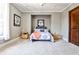 This bedroom features carpet, light-colored walls, and a bed built into an alcove at 4309 Sentinel Post Nw Rd, Atlanta, GA 30327
