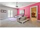 This versatile bonus room has carpet, a pink accent wall, and a reading nook at 4309 Sentinel Post Nw Rd, Atlanta, GA 30327
