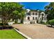 Elegant home with a gravel driveway, manicured landscaping, stone accents, and a grand entrance at 4309 Sentinel Post Nw Rd, Atlanta, GA 30327
