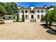 Majestic home with a circular gravel driveway, manicured landscaping, and a stunning architectural design at 4309 Sentinel Post Nw Rd, Atlanta, GA 30327