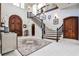 Grand foyer featuring a staircase with iron railings, a marble floor, and a chandelier at 4309 Sentinel Post Nw Rd, Atlanta, GA 30327