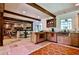 Warm kitchen with wooden cabinets, stone countertops, and an open dining area at 4309 Sentinel Post Nw Rd, Atlanta, GA 30327