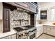 Gourmet kitchen with stainless steel range, custom cabinetry, and decorative backsplash at 4309 Sentinel Post Nw Rd, Atlanta, GA 30327