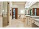 Luxurious bathroom featuring travertine tile, a soaking tub, and and vanities at 4309 Sentinel Post Nw Rd, Atlanta, GA 30327