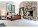 Elegant main bedroom featuring a stone fireplace, large windows, and unique wood bed frame at 4309 Sentinel Post Nw Rd, Atlanta, GA 30327