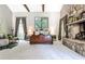 Bright main bedroom with high ceilings, a cozy seating area, and a stone fireplace at 4309 Sentinel Post Nw Rd, Atlanta, GA 30327