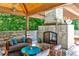 Outdoor kitchen with a cozy fireplace and gathering spot that creates a warm atmosphere at 4309 Sentinel Post Nw Rd, Atlanta, GA 30327
