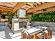 Covered outdoor stone kitchen with fireplace and seating, perfect for outdoor dining and relaxation at 4309 Sentinel Post Nw Rd, Atlanta, GA 30327