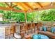 A beautiful, full outdoor kitchen with bar top seating, wood-burning oven and stainless steel appliances at 4309 Sentinel Post Nw Rd, Atlanta, GA 30327