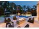 Beautiful pool area with a lounge area, fire pit, cabana, outdoor kitchen, and diving board at 4309 Sentinel Post Nw Rd, Atlanta, GA 30327