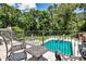 Enjoy this backyard view of a large pool surrounded by lush trees and blue skies at 4309 Sentinel Post Nw Rd, Atlanta, GA 30327