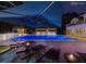 Night view of luxury backyard with beautiful pool, lounge chairs, and outdoor kitchen at 4309 Sentinel Post Nw Rd, Atlanta, GA 30327