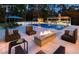 Backyard patio with a fireplace, outdoor kitchen, lounge chairs, and diving board at 4309 Sentinel Post Nw Rd, Atlanta, GA 30327