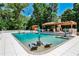 A backyard swimming pool with chairs in the water, a pool house, and diving board, perfect for outdoor enjoyment at 4309 Sentinel Post Nw Rd, Atlanta, GA 30327