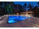 A luxurious swimming pool with pool house and diving board set against a backdrop of lush trees at 4309 Sentinel Post Nw Rd, Atlanta, GA 30327