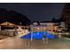 A luxury home with pool, diving board, and outdoor kitchen, illuminated at night with a backyard view at 4309 Sentinel Post Nw Rd, Atlanta, GA 30327