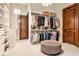 Spacious walk-in closet with custom shelving, ample storage, and a stylish ottoman at 4309 Sentinel Post Nw Rd, Atlanta, GA 30327