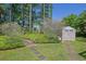 Well-maintained backyard featuring lush landscaping, stone paver accents, and a storage shed at 530 Chicapoo Dr, Marietta, GA 30066