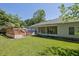 Lush backyard featuring a hot tub with wooden deck, screened porch, and well-maintained lawn at 530 Chicapoo Dr, Marietta, GA 30066