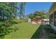 Large backyard with mature trees, storage shed, hot tub with deck, and screened-in porch at 530 Chicapoo Dr, Marietta, GA 30066