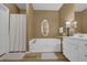 This bathroom features a soaking tub, white vanity, and wood flooring at 530 Chicapoo Dr, Marietta, GA 30066