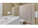Neutral bathroom featuring a white vanity, framed mirror, and patterned shower curtain at 530 Chicapoo Dr, Marietta, GA 30066