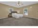 This bedroom features carpet, a queen-size bed, two windows, and a modern ceiling fan at 530 Chicapoo Dr, Marietta, GA 30066